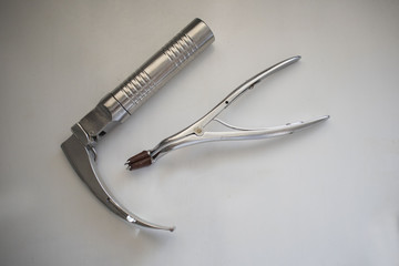 laryngoscope and tongue depressor on the medical table