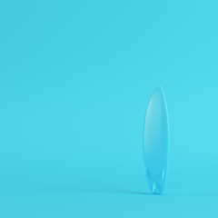 Surfboard on bright blue background in pastel colors. Minimalism concept