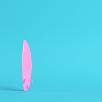 Pink surfboard on bright blue background in pastel colors. Minimalism concept