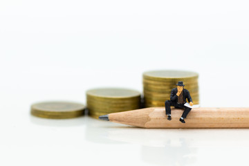 Miniature people sitting on pencil using as background education or business concept
