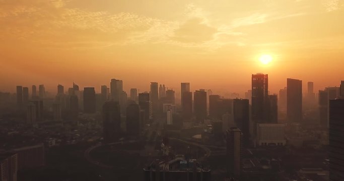 JAKARTA, Indonesia - May 22, 2018: Beautiful aerial landscape of Jakarta city with skyscrapers background circa Semanggi CBD on foggy day at dusk time. Shot in 4k resolution