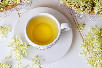 Obraz na płótnie Canvas A cup of herbal tea with fresh elder flowers