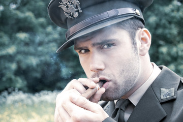 Handsome American WWII GI Army officer in uniform smoking cigar