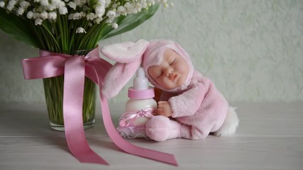 toy with baby milk sits on a table near flowers. For baby shower. for thematic birthday decor