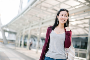 Summer sunny lifestyle fashion portrait of young stylish hipster woman walking on the street, wearing cute trendy outfit