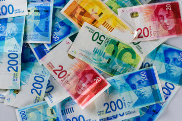 Stack of various Israeli shekel bills. Israel money banknotes of 50, 20, 100 and 200.NIS - New Israeli Shekels background. Top view..