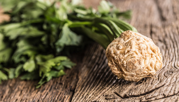 Fresh celery root with leaf on rustic oak table