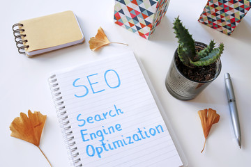 SEO Search Engine Optimization written in notebook on white table - obrazy, fototapety, plakaty