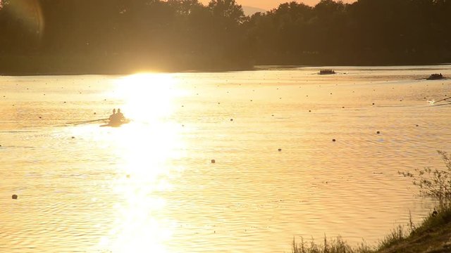Jarun lake near Zagreb, Croatia. Sport and recreation. Rowing, kayak and canoe. Rowing team training at sunset