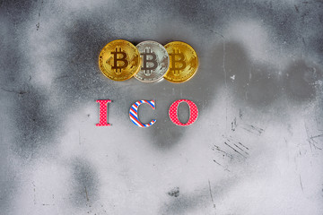 ICO initial coin offering. Modern silver foil mystic background with a bitcoins  and ICO word. In...