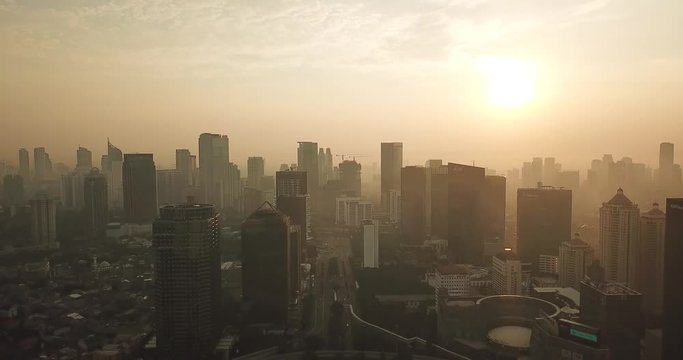 JAKARTA, Indonesia - May 22, 2018: Beautiful aerial landscape of Semanggi CBD with skyscrapers and Sudirman street from a drone flying backwards on the morning. Shot in 4k resolution