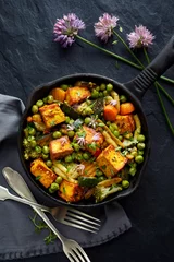 Fotobehang Gerechten Tofu with vegetables sprinkled with herbs and edible flowers, top view. Vegan dish delicious and nutritious. Healthy eating concept