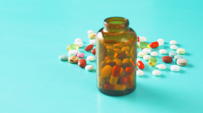 Medical pills and a bottle lie on the table. Medical concept