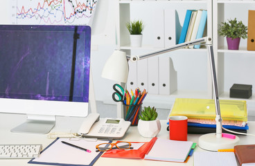 Workplace with notebook laptop Comfortable work table in office windows and city view