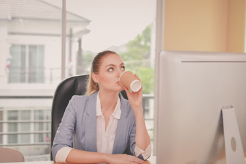Fototapeta premium Business Concepts. Beautiful businesswoman is working in office. Beautiful young businesswoman is working on a computer. Beautiful young businesswoman is working happily.