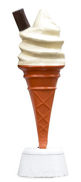 Vintage plastic promotional UK ice cream cone with vanilla whipped ice cream and a chocolate flake isolated against a white background
