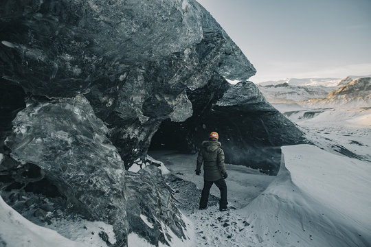Young man exploring Ice cave in Iceland