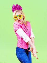 Mature woman with big bow on her head dressed in pink clothes