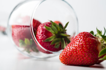 scattered strawberries on a white background