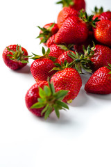 scattered strawberries on a white background