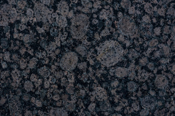 Dark textured stone surface.