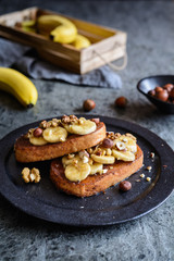 Fototapeta na wymiar Cinnamon French toast with banana, walnut and hazelnut
