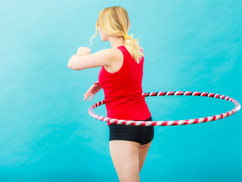 Fit woman with hula hoop doing exercise