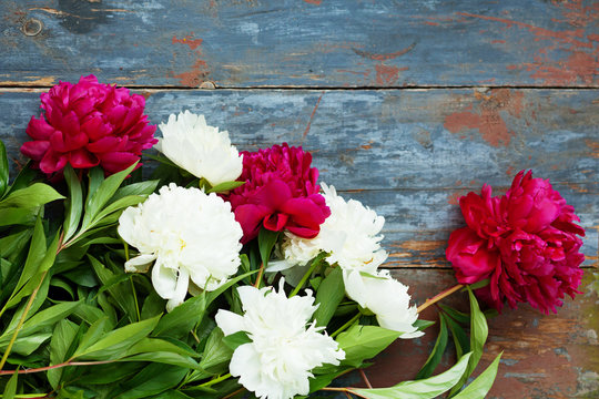 Peony background. Pink and peonies on wooden table with place for text. Spring flower peony. Happy Mothers Day. Mother's Day greetings card. Mothers Day gift. Copy space.