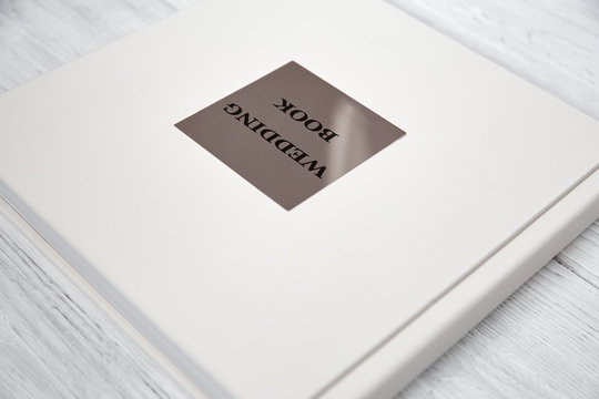 light wedding book on a white wooden background
