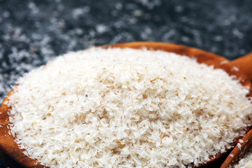 Portion of Psyllium Seeds on rustic dark background. Psyllium seed husks