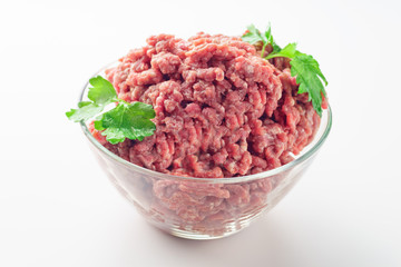 Raw minced meat in a plate on white background