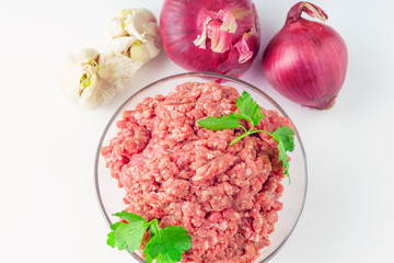 Raw minced meat in a plate on white background