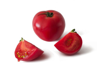 Tomato and two slices of chopped tomato. Isolated on white background