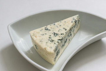 Blue cheese in a white triangular plate