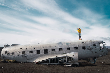 Photographer on wrecked plain in nature