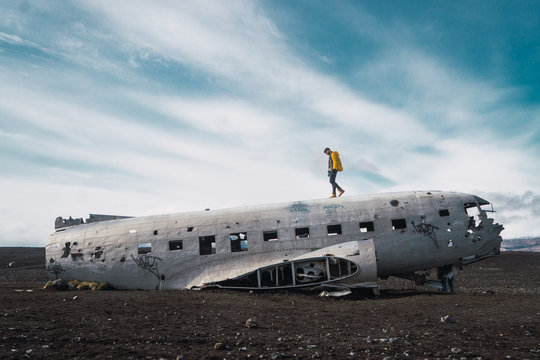 Photographer on wrecked plain in nature
