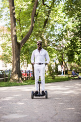 Handsome young afro american businessman on hoverboard. Evolution of business.