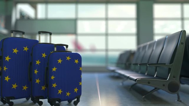 Travel suitcases featuring flag of the European Union. EU tourism conceptual animation
