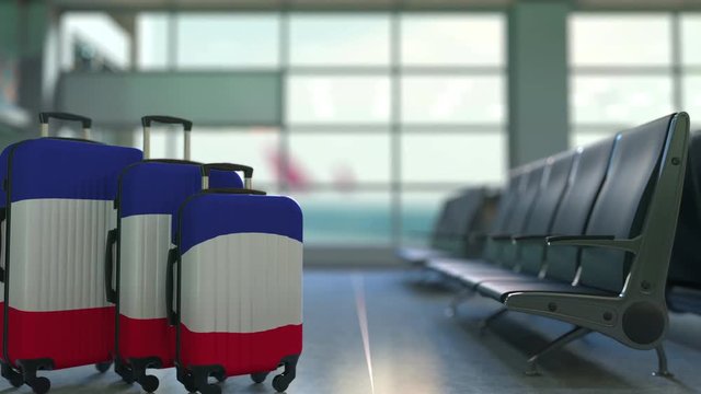 Travel suitcases featuring flag of France. French tourism conceptual animation