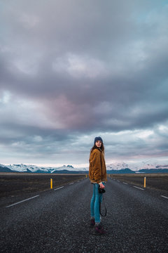 Woman on road looking at camera