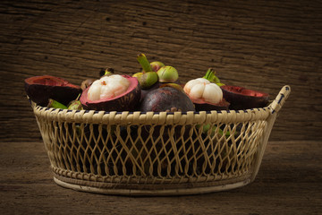 magosteen in basket on old wood