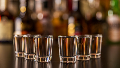 Traditional pure vodka in glasses on a black background, chilled drink