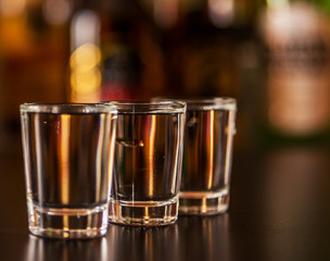 Traditional pure vodka in glasses on a black background, chilled drink
