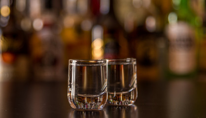 Traditional pure vodka in glasses on a black background, chilled drink