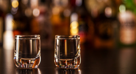 Traditional pure vodka in glasses on a black background, chilled drink