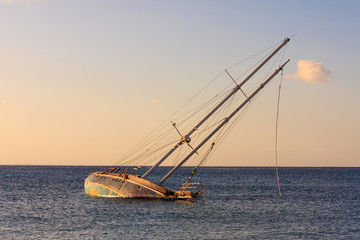 Shipwrech. sinking yacht and sunset colors