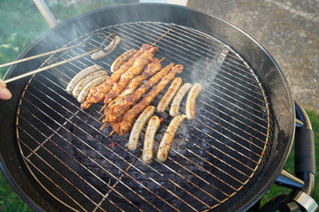 Sausages barbecue with a charcoal barbecue in the garden
