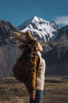 Woman with flaying hair in mountains