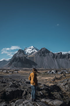 Woman with flaying hair in mountains