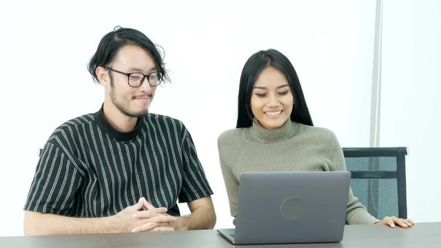 Asian people looking to laptop at meeting room together. People working concept. 
